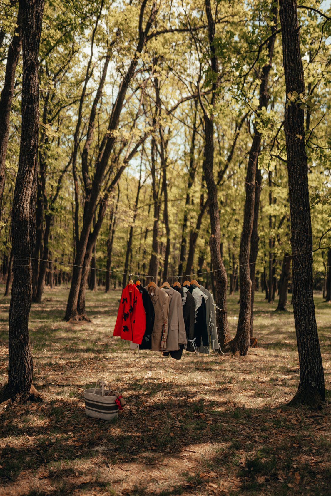 The re.born collection hung on a line strung between trees in the forest outside Cluj-Napoca