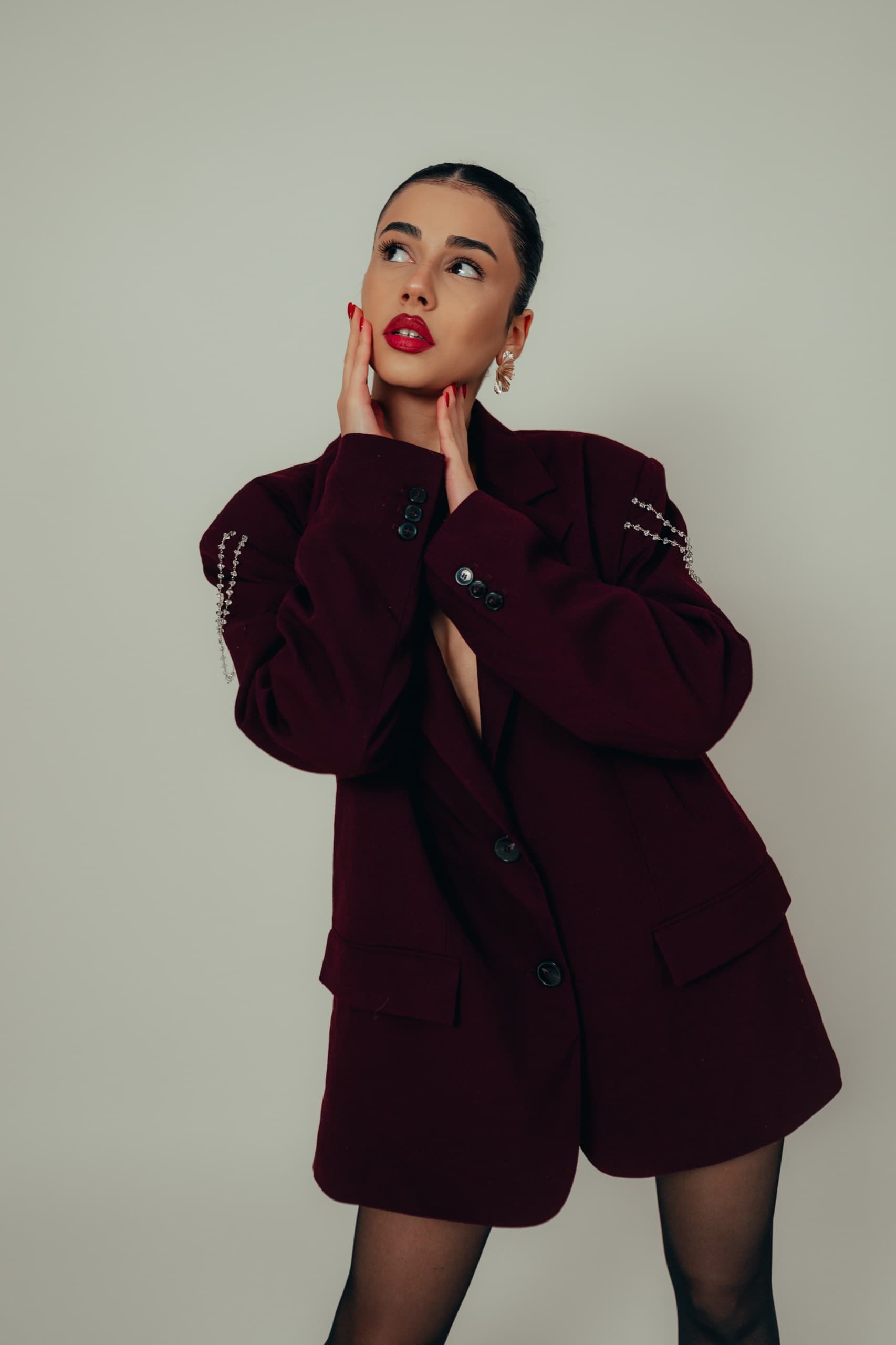 Oversized burgundy blazer with crystal chain embellishments on both sleeves