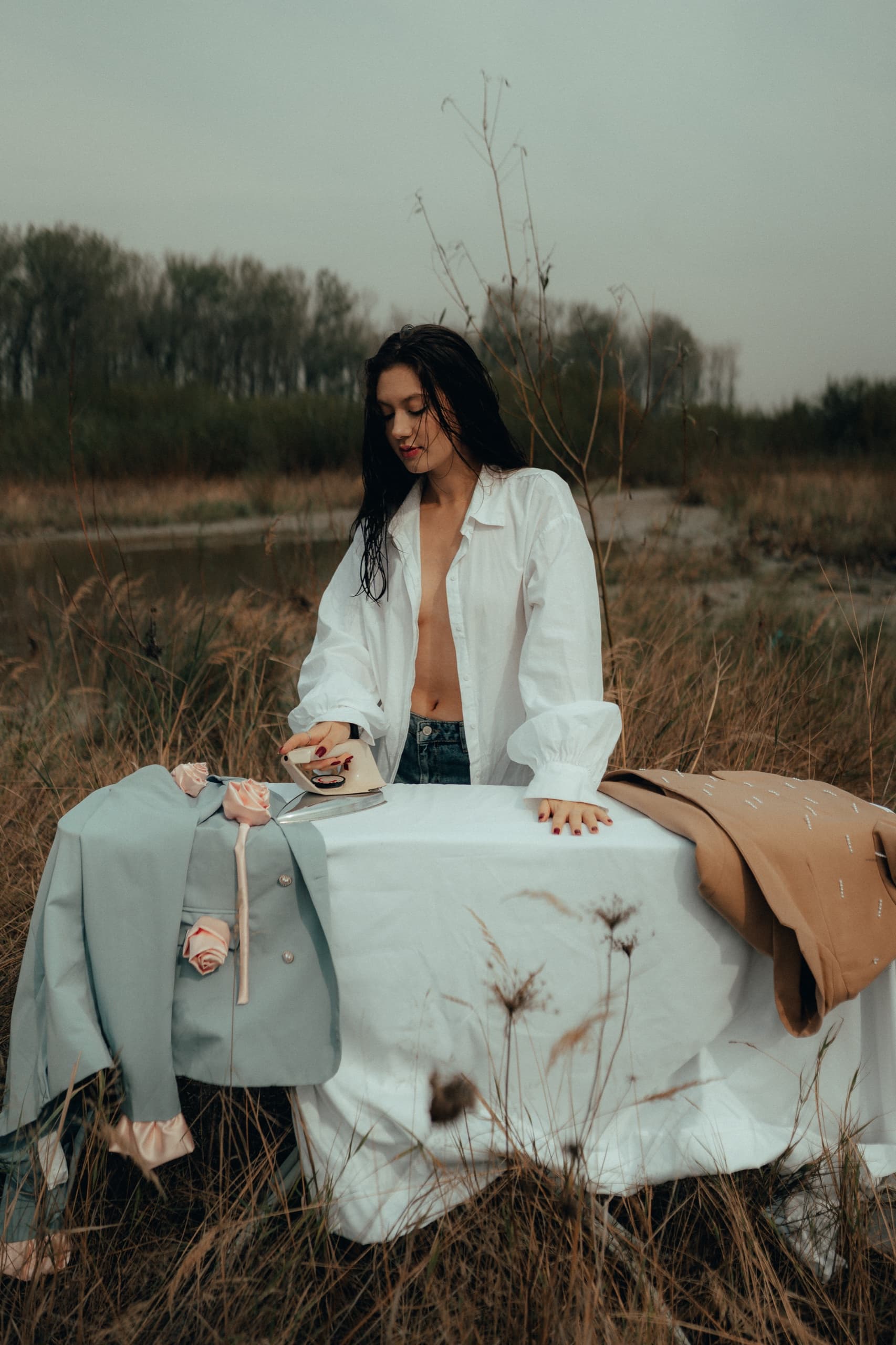 Pressing re.born blazers on a cloth-covered table in a dry autumn field