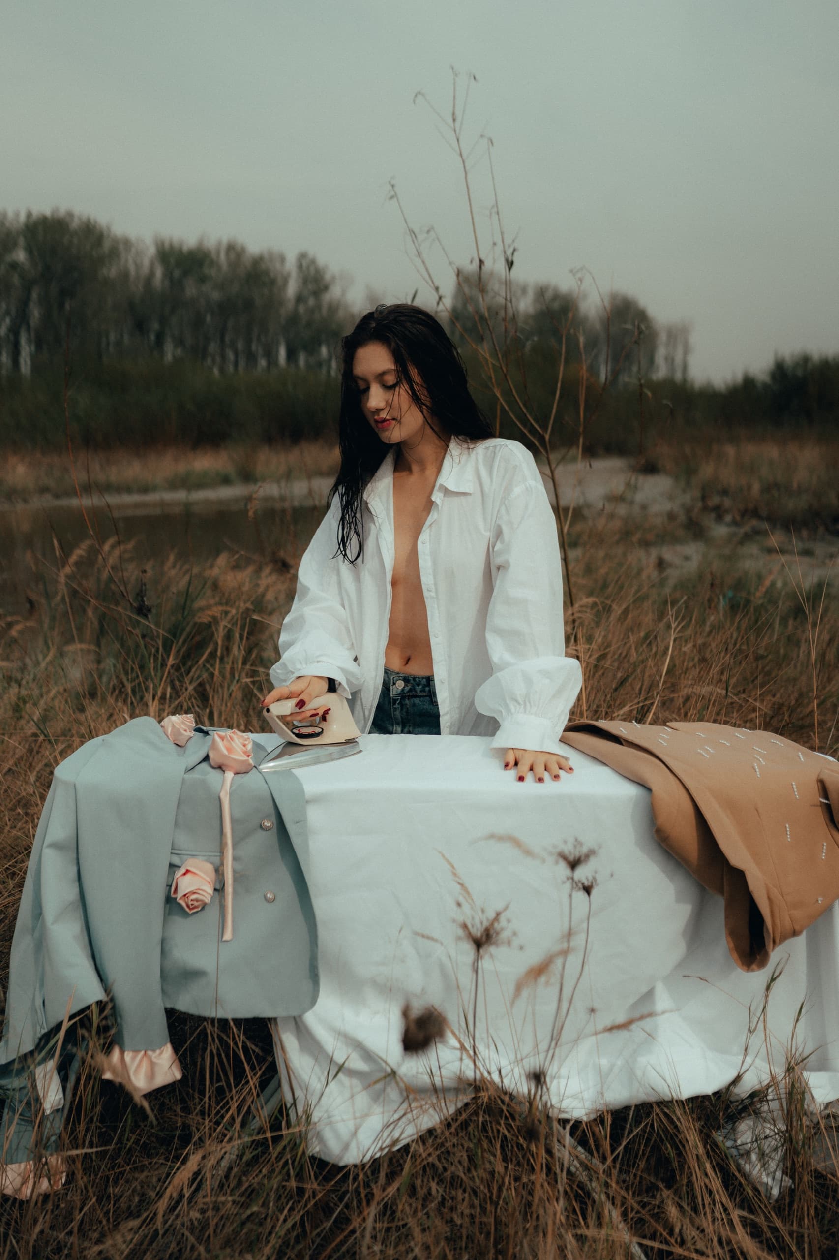 Pressing re.born blazers on a cloth-covered table in a dry autumn field