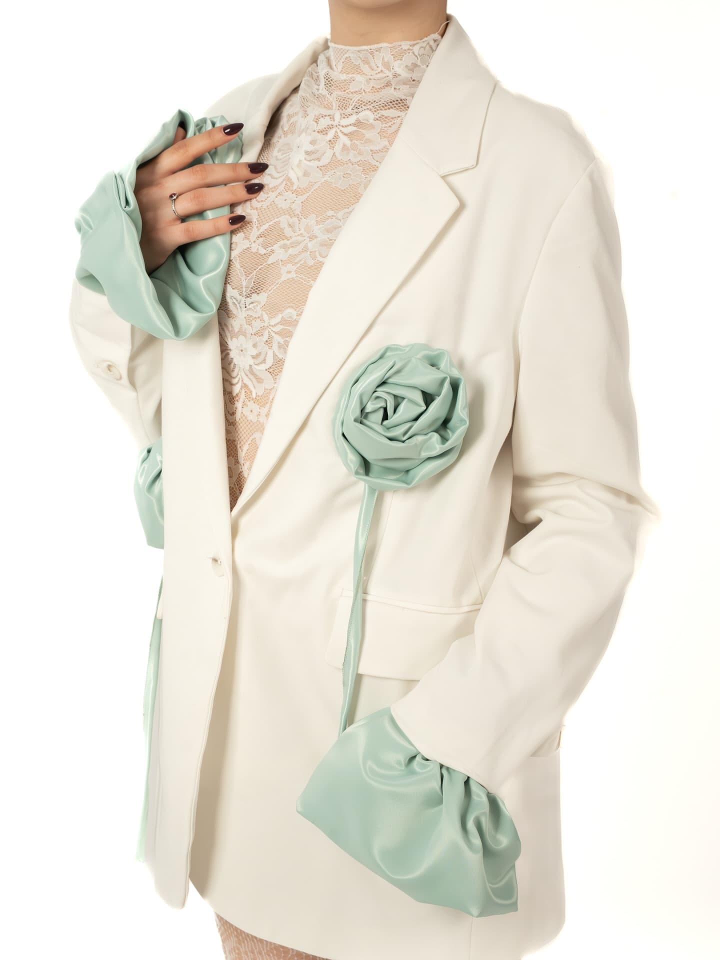 White blazer with a mint satin rosette on the chest and gathered satin cuffs
