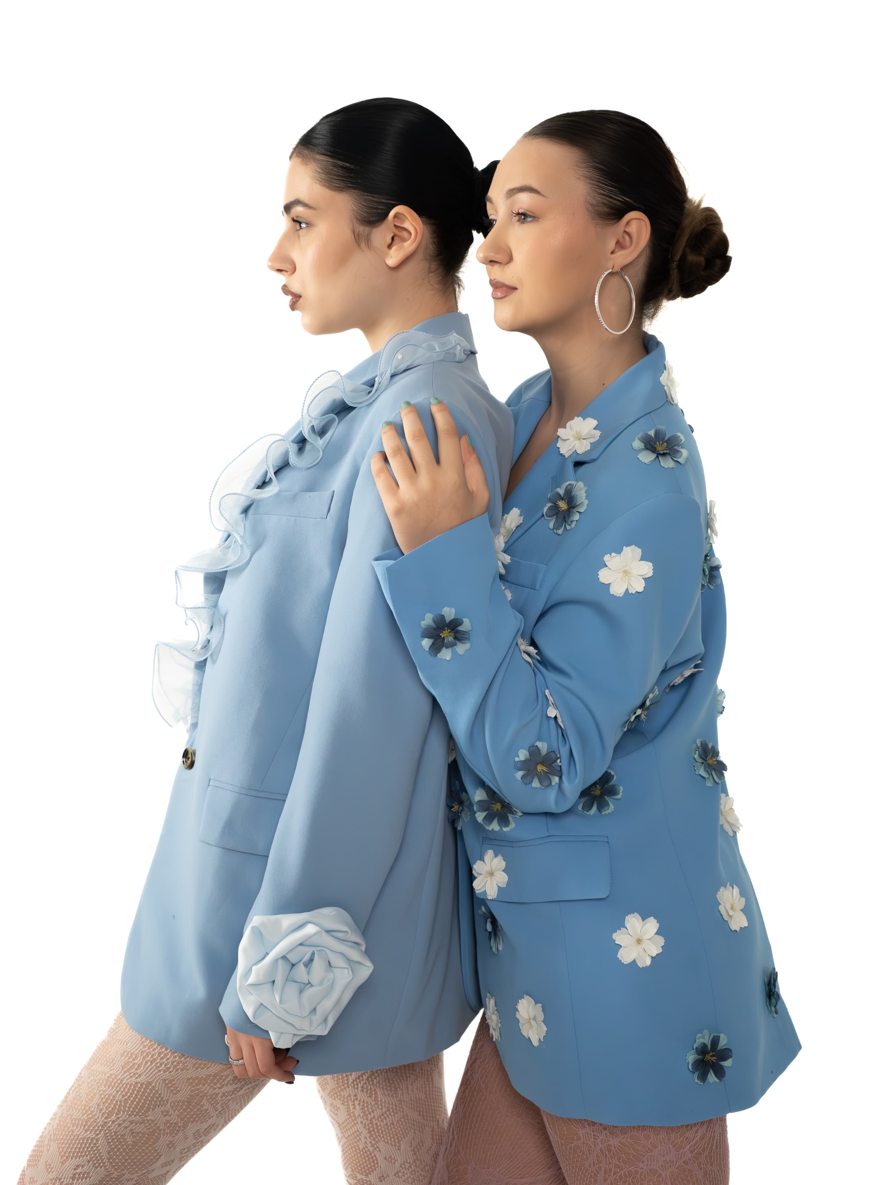 Two light blue blazers, one trimmed with organza ruffles, one covered in applique flowers
