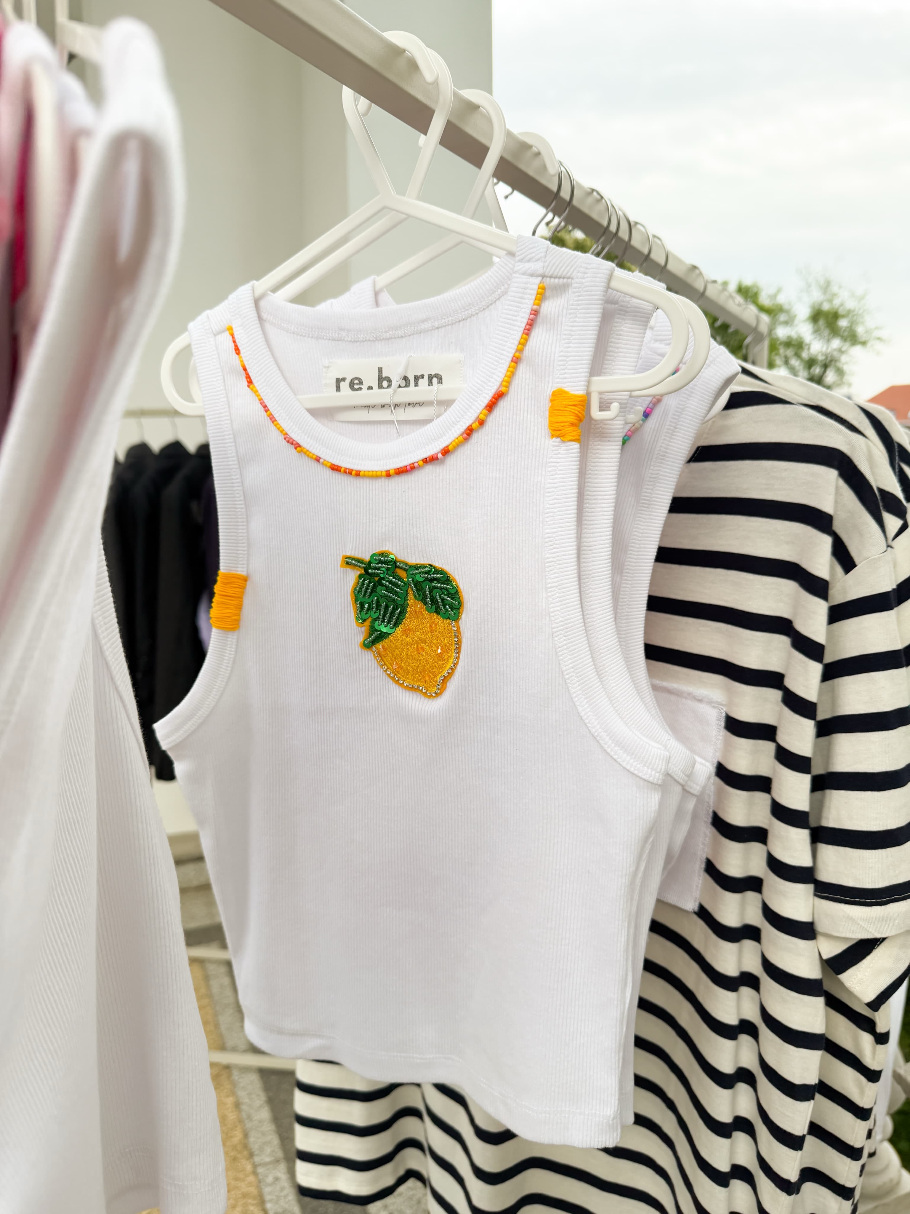 White ribbed tank with a beaded neckline and a sequinned lemon patch