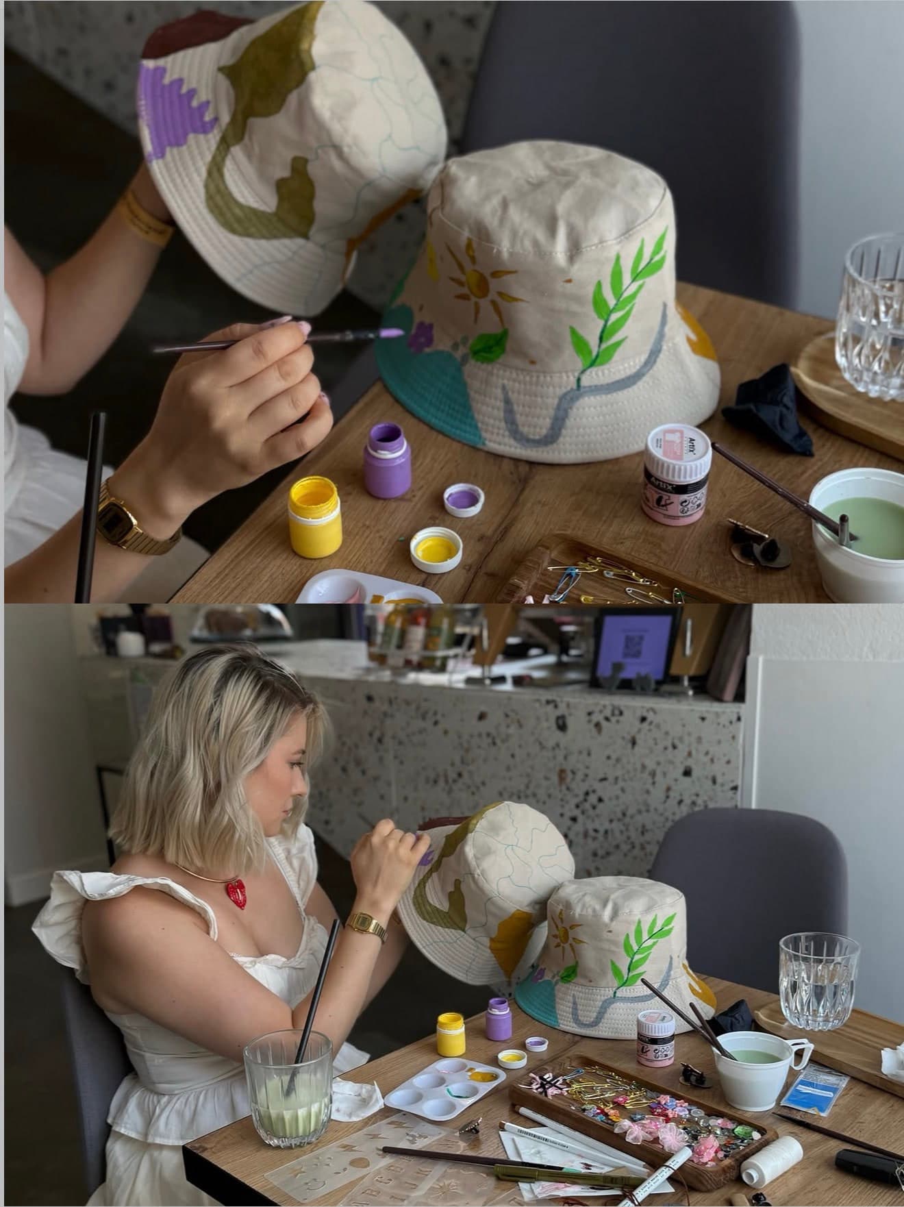 Hands painting a bucket hat at a workshop table crowded with paints and brushes